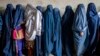 FILE - Afghan women wait to receive food rations distributed by a humanitarian aid group, in Kabul, Afghanistan, Tuesday, May 23, 2023. The Taliban have reportedly allowed female high school graduates to enroll in state-run medical institutes.