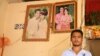Suon Sakhen, spouse of the victim, stands in front of his wedding photos inside his house, in Chantrea district, Svay Rieng province, Feb 8, 2019. (Sun Narin/VOA Khmer) 