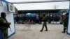 Ukrainian citizens are guarded by Russia-backed separatist fighters during a prisoner swap near Mayorsk, Donetsk region, Ukraine, Dec. 29, 2019. 
