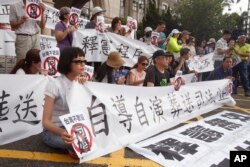 FILE - Protesters of same-sex marriage hold banners and signs reading, "Same-sex marriage is unwelcome in Taiwan" after Taiwan's Constitutional Court ruled in favor of same-sex marriage on Wednesday outside of the Legislative Yuan in Taipei, Taiwan, May 24, 2017.