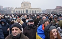 Armenian opposition supporters rally demanding the resignation of Prime Minister Nikol Pashinyan over a controversial peace deal with Azerbaijan that ended six weeks of war over the disputed region of Nagorno-Karabakh, in Yerevan, Dec. 22, 2020.