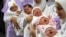 FILE - Nurses hold newborn babies in Sidon, Lebanon, Oct. 31, 2011. 