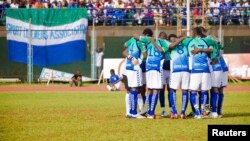 FILE - Sierra Leonean players huddle at their match against Niger at the national stadium, Freetown, June 2011.