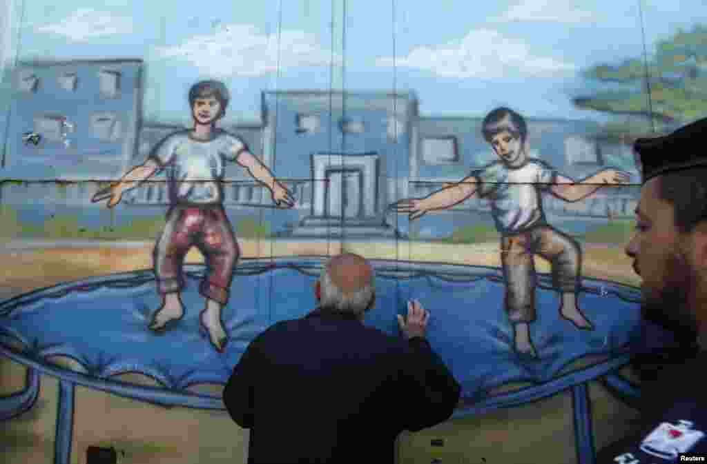 Seorang pengungsi Palestina terlihat melalui pintu gerbang Badan Bantuan PBB dan Pekerjaan UNRWA), selama protes menuntut para pengungsi agar PBB melanjutkan bantuan keuangan di kota Gaza.