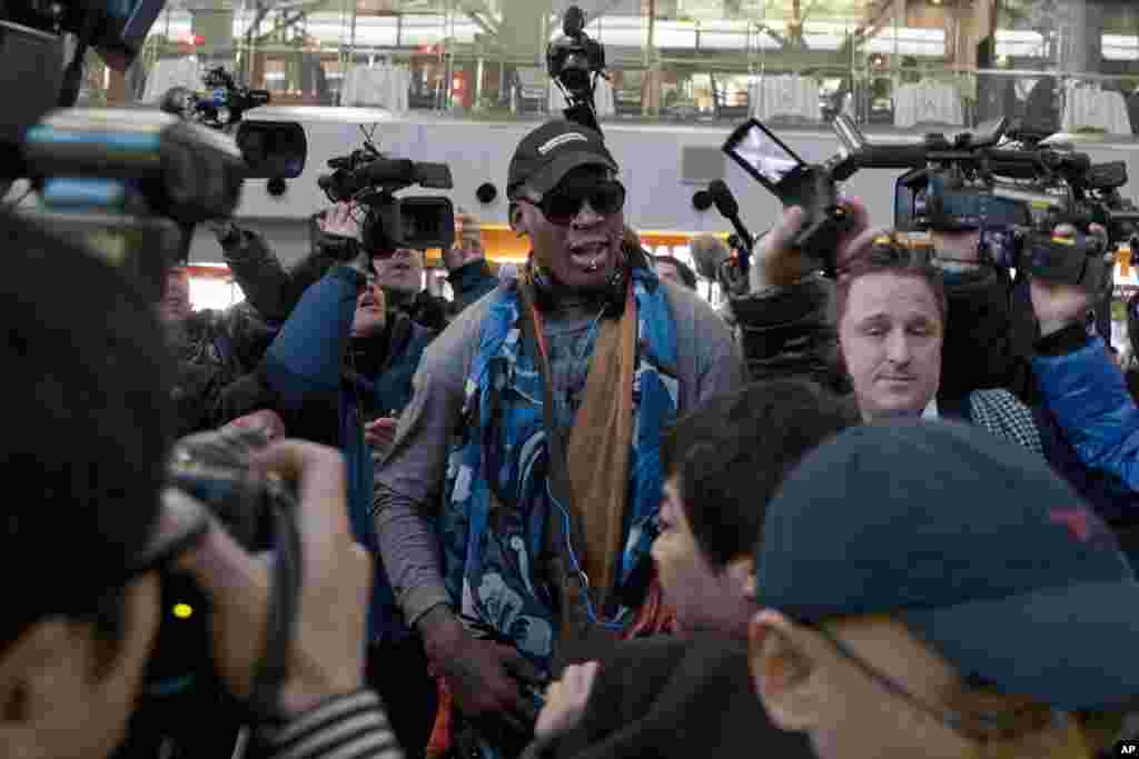 Mantan bintang NBA Dennis Rodman (tengah) tiba di bandar udara Beijing, China (19/12), sebelum terbang ke Pyongyang. (AP/Ng Han Guan)
