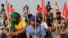 Farmers block railway tracks as part of protests against farm laws during nationwide protests, in Sonipat, northern state of Haryana, India, Sept. 27, 2021. 