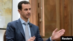 Syria's President Bashar al-Assad is interviewed Feb. 10, 2017, in Syria. Thousands of Afghans from Iran are involved in the Syrian conflict, many sent against their will, Human Rights Watch reports.