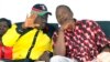 The National Alliance Party (TNA) presidential candidate Deputy Prime Minister Uhuru Kenyatta right, and his running mate William Ruto, talk during a rally at Uhuru Park, in Nairobi, January 12, 2013. 