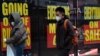 FILE - Sale and going-out-of-business signs are displayed in a store window in the Brooklyn borough of New York City, Dec. 1, 2020. 