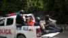 Police take two detainees to the police station of Petion Ville, Port-au-Prince, Haiti, July 8, 2021. According to Police Chief Leon Charles, the two detainees are suspects in the assassination of Haitian President Jovenel Moïse. 