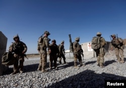 FILE - US troops wait for their helicopter flight at an Afghan National Army (ANA) Base in Logar province, Afghanistan.