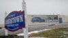 A banner depicting the Chevrolet Cruze vehicle is displayed at the General Motors' Lordstown plant, Nov. 27, 2018, in Lordstown, Ohio. Even though the economy is growing, GM is cutting thousands of jobs in a major restructuring aimed at generating cash to