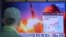 A man watches a TV screen showing a file image of North Korea's missile launch during a news program at the Seoul Railway Station in Seoul, South Korea, Sunday, March 29, 2020. 