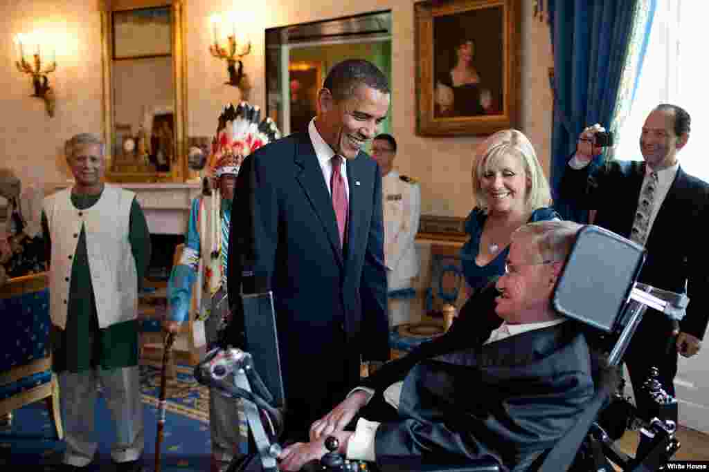 President Barack Obama talks with Stephen Hawking in the Blue Room of the White House before a ceremony presenting him and 15 others the Presidential Medal of Freedom, August 12, 2009. The Medal of Freedom is the nation's highest civilian honor. (Officia
