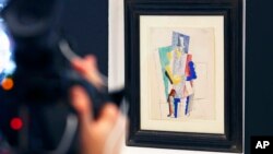 Picasso's 1914 cubist drawing L'Homme au Gibus, Man with Opera Hat, is presented at Sotheby's auction house in Paris, Dec. 12, 2013. 