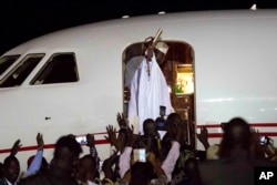 FILE - Gambia's defeated leader Yahya Jammeh waves to supporters as he departs from Banjul airport, Jan. 21, 2017.
