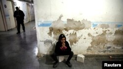 A relative of a wounded fighter waits for the end of his surgery in a hospital in Idlib, Syria, Feb. 28, 2020. 