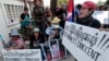 Boeung Kak lake community's land activists shout slogans with a poster of detained Tep Vanny during a rally in front of an appeals court in Phnom Penh, Cambodia, Tuesday, Aug. 8, 2017. The court upheld a 2 ½ year prison term against Tep Vanny, a prominent land rights activist on charges of committing violence at a protest she helped lead outside of Prime Minister Hun Sen's residence more than three years ago. (AP Photo/Heng Sinith)