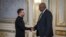 This handout photograph taken and released by the Ukrainian Presidential Press Service on October 21, 2024 shows Ukrainian President Volodymyr Zelensky (L) and US Secretary of Defense Lloyd Austin shaking hands during their meeting in Kyiv.