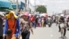 Garment workers walk along the Confederation de la Russia Boulevard in Phnom Penh, Cambodia, during a lunch break. (Photo: Khan Sokummono/VOA Khmer)