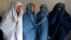 Male Afghan women's rights activists pose for media as they wear burqas to show their solidarity to Afghan women ahead of International Women's Day in Kabul, March 5, 2015. 
