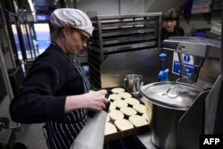 A staff member prepares to bake a tray of pies at the traditional pie and mash shop G Kelly in east London, Feb. 19, 2025. Londoners have been eating classic pie and mash since at least Victorian times.