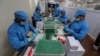 FILE - Employees pack boxes containing vials of Covishield, a version of the AstraZeneca vaccine at the Serum Institute of India in Pune, India, Jan. 21, 2021.