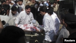 Hospital staff assist Malala Yousufzai, a 14-year-old schoolgirl who was wounded in a gun attack, at Saidu Sharif Teaching Hospital in the Swat Valley region in northwest Pakistan, October 9, 2012.
