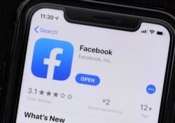 FILE - The Facebook application is displayed on a mobile phone at a store in Chicago, July 30, 2019.