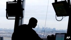 FILE - In this May 21, 2015 file photo, an air traffic controller works in a tower at Newark Liberty International Airport. African air traffic safety and security experts are calling for more investment to guarantee safe air travel on the continent.
