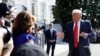 FILE - President Donald Trump talks to reporters on the South Lawn of the White House, Aug. 9, 2019, in Washington.