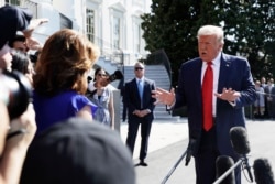 FILE - President Donald Trump talks to reporters on the South Lawn of the White House, Aug. 9, 2019, in Washington.