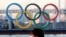 A man stands in front of a countdown clock for Tokyo Olympic and Paralympic Games in Tokyo, Feb. 3, 2021.