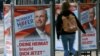 A woman walks past election posters of Norbert Hofer, candidate for presidential elections of Austria's right-wing Freedom Party, FPOe, in Vienna, Austria, April 19, 2016. The posters read "Your country needs you now."