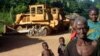 Congolese people standing in front of two bulldozers in Yayolo, Democratic Republic of Congo, October 2004. (file photo)