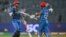 Afghanistan's Azmatullah Omarzai (L) celebrates with his captain Hashmatullah Shahidi after scoring a half-century (50 runs) during the 2023 ICC Men's Cricket World Cup one-day international (ODI) match between Afghanistan and Sri Lanka at the Maharashtra