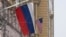 A Russian flag flies next to a U.S. flag at the U.S. Embassy in Moscow on March 13, 2025. U.S. special envoy Steve Witkoff arrived in Moscow Thursday to meet with Russian officials about a Ukraine-Russia ceasefire proposal.