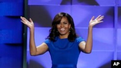 First Lady Michelle Obama takes the stage to thunderous applause