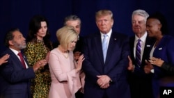 FILE - Faith leaders pray with President Donald Trump during a rally for evangelical supporters at the King Jesus International Ministry church in Miami.