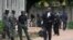 Lawyers walk past police officers standing guard outside a court, that is set to rule on Shi'ite leader Zakzaky's bail application, in Kaduna, Nigeria July 29, 2019. 