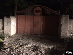 The red metal gate where the tour bus waited for the arrival of police. (S. Lemaire/VOA)