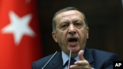 Turkey's Prime Minister Recep Tayyip Erdogan addresses supporters and lawmakers at the parliament in Ankara, Turkey, May 14, 2013.