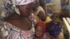Aissatou Jowel, left, lives with her children at the refugee camp in Minawao, Cameroon. She says it would be too painful to return to her home in Nigeria, where Boko Haram rebels killed her husband. (Moki Edwin Kinzeka / VOA) 