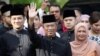 Malaysia's Prime Minister Designate and former interior minister Muhyiddin Yassin waves to reporters before his inauguration as the 8th prime minister, outside his residence in Kuala Lumpur, Malaysia, March 1, 2020. REUTERS/Lim Huey Teng TPX…