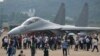 Visitors look at the Chinese military's J-16D electronic warfare airplane during 13th China International Aviation and Aerospace Exhibition, also known as Airshow China 2021, on Wednesday, Sept. 29, 2021, in Zhuhai in southern China's Guangdong province. 
