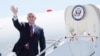 Vice President Mike Pence waves as he stops off Air Force Two after arriving at the Des Moines International Airport before meeting with faith leaders and food industry executives in response to the coronavirus pandemic, May 8, 2020, in Des Moines, Iowa. 