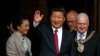  China's President Xi Jinping, center, waves as he leaves after lunch with Britain's Prime Minister David Cameron at Manchester Town Hall in Manchester, England, Oct. 23, 2015.
