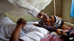 FILE - A patient with hepatitis is treated at a hospital in El Sereif village, North Darfur, Sudan.
