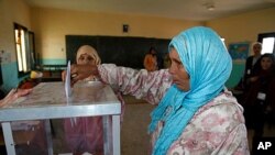A woman casts her ballot at a polling station in Rabat, November 25, 2011.