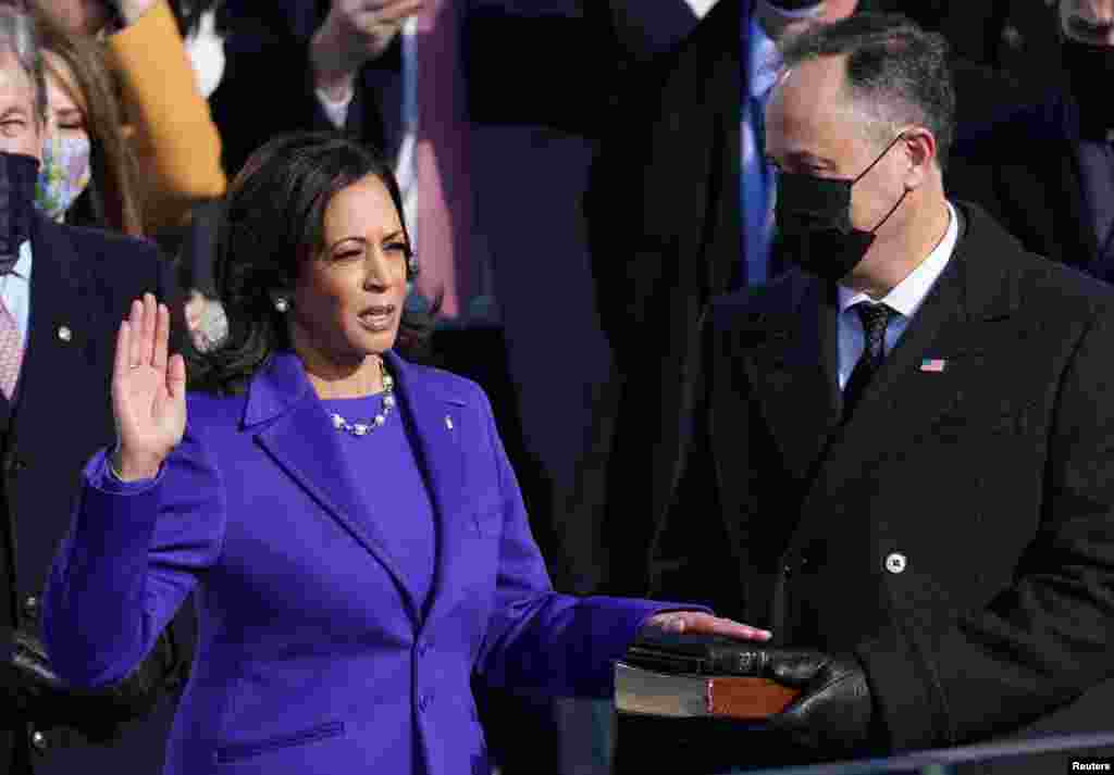 Kamala Harris diambil sumpahnya sebagai Wakil Presiden, sementara suaminya Doug Emhoff memegang Alkitab pada acara inagurasi di Washington D.C. (Foto: REUTERS)